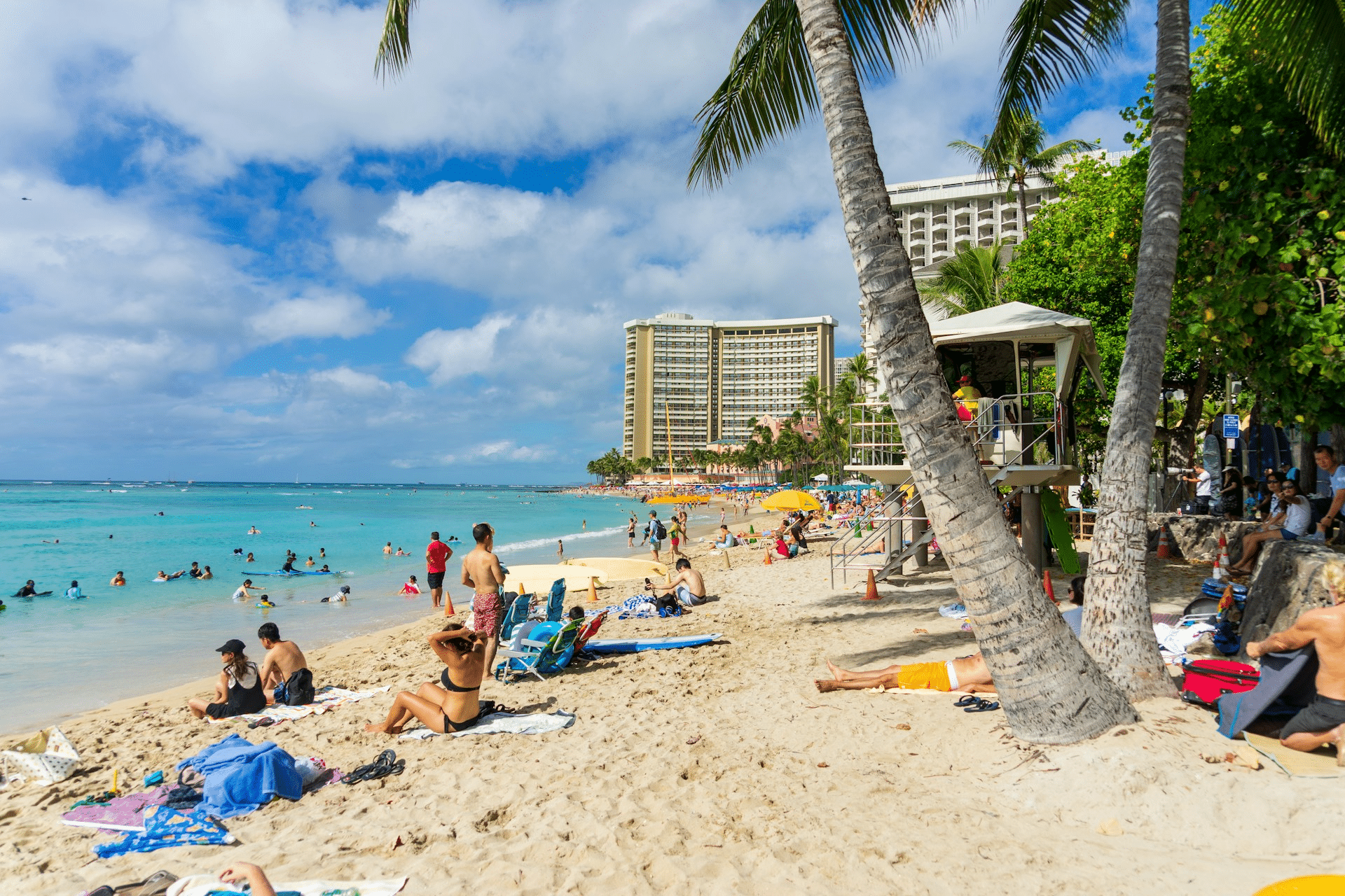 Families enjoying a beach day on Oahu